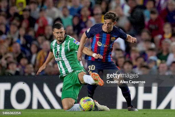Guido Rodriguez of Real Betis competes for the ball with Gavi of FC Barcelona during the LaLiga Santander match between FC Barcelona and Real Betis...