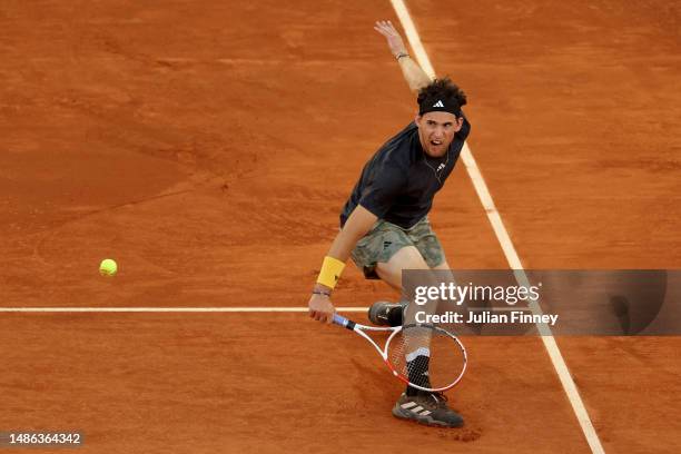 Dominic Thiem of Austria plays a backhand against Stefanos Tsitsipas of Greece during the Men's Round of 64 match on Day Six of the Mutua Madrid Open...