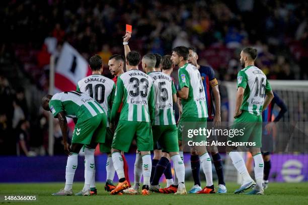 Referee, Sacchi di Macerata shows a red card to Edgar of Real Betis during the LaLiga Santander match between FC Barcelona and Real Betis at Spotify...