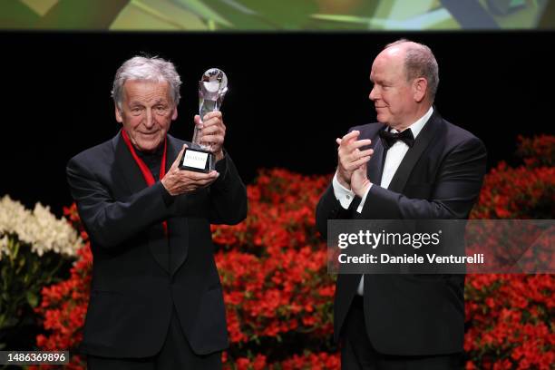 Costa-Gavras and Prince Albert II of Monaco are seen on stage with an award during the 20th Monte-Carlo Film Festival De La Comedie at Grimaldi Forum...