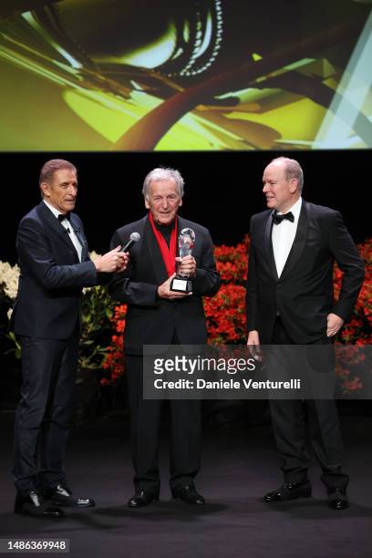 Ezio Greggio, Costa-Gavras and Prince Albert II of Monaco are seen on stage with an award during the 20th Monte-Carlo Film Festival De La Comedie at...