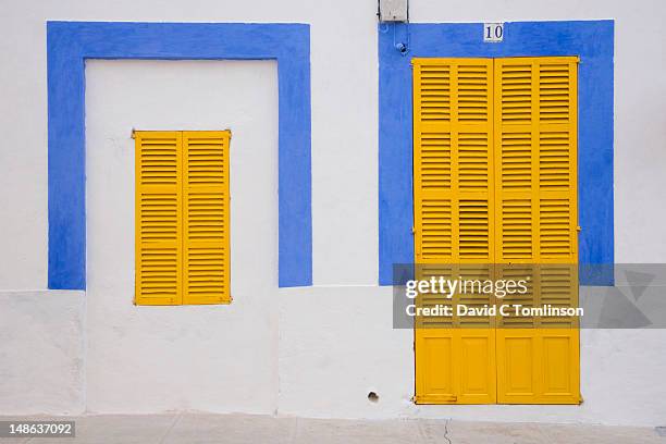 facade of blue and white house with yellow shutters in the old town. - shutter stock pictures, royalty-free photos & images