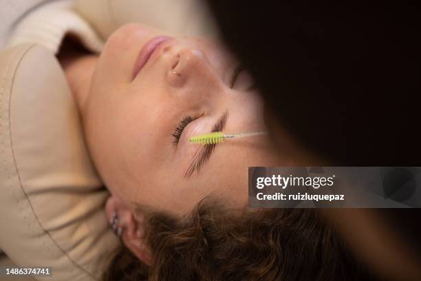 young woman during eyebrow lamination procedure - brow lamination stock pictures, royalty-free photos & images
