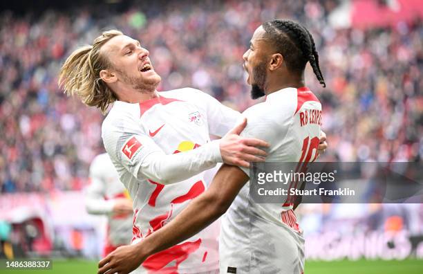 Christopher Nkunku of RB Leipzig celebrates with Emil Forsberg after scoring his sides first goal during the Bundesliga match between RB Leipzig and...