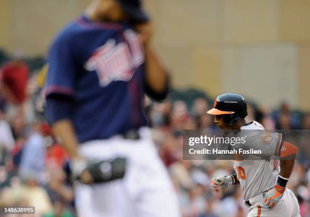 Francisco Liriano of the Minnesota Twins looks on as Adam Jones of the Baltimore Orioles rounds the bases after a two-run home run during the first...