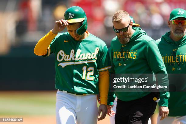 Aledmys Diaz of the Oakland Athletics exits the game against the Cincinnati Reds after sustaining an injury in the bottom of the second inning at...