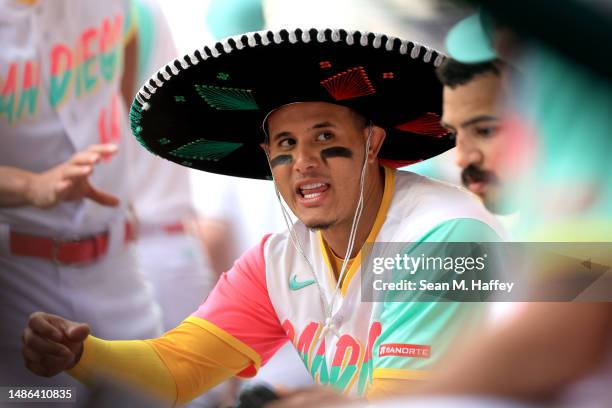 Manny Machado of the San Diego Padres talks with teammates in the dugout after hitting a solo homerun during the fifth inning of the MLB World Tour...