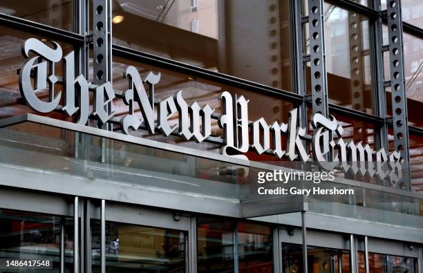 The New York Times logo hangs above a doorway of their corporate headquarters on April 29 in New York City.