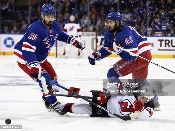 Jack Hughes of the New Jersey Devils is hit by Chris Kreider of the New York Rangers during the first period in Game Six of the First Round of the...