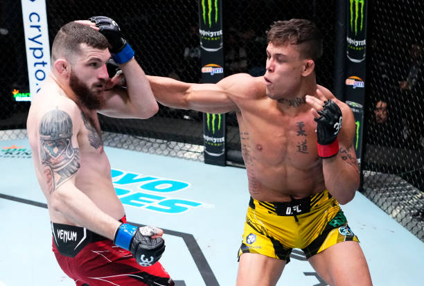 Caio Borralho of Brazil punches Michal Oleksiejczuk of Poland in a middleweight fight during the UFC Fight Night event at UFC APEX on April 29, 2023...