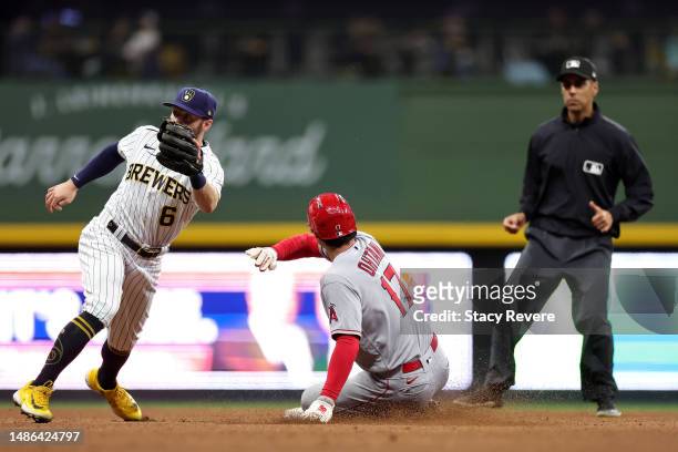 Shohei Ohtani of the Los Angeles Angels beats a tag by Owen Miller of the Milwaukee Brewers to steal second base during the eighth inning at American...