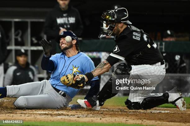 Josh Lowe of the Tampa Bay Rays is safe at home plate in the seventh inning of the game against Yasmani Grandal of the Chicago White Sox at...