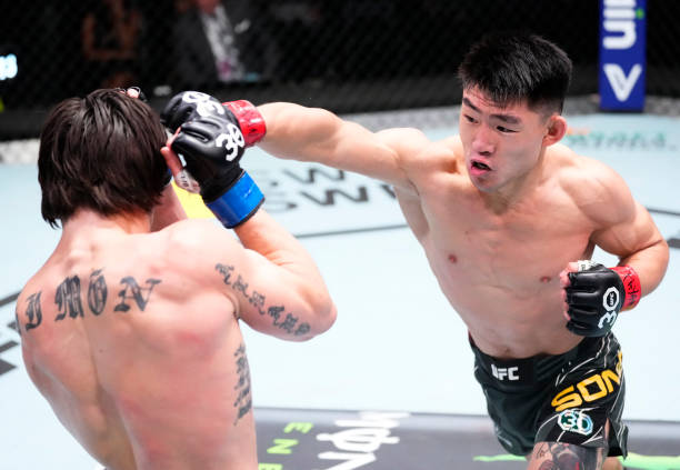 Song Yadong of China punches Ricky Simon in a bantamweight fight during the UFC Fight Night event at UFC APEX on April 29, 2023 in Las Vegas, Nevada.