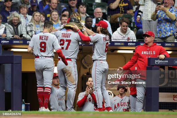 Mike Trout of the Los Angeles Angels is congratulated by Brett Phillips following a two run home run against the Milwaukee Brewers during the eighth...
