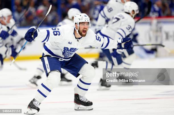 Erik Gustafsson of the Toronto Maple Leafs celebrate winning Game Six of the First Round of the 2023 Stanley Cup Playoffs on an overtime goal by John...