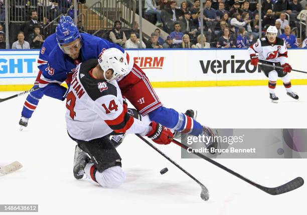 Andre Miller of the New York Rangers checks Nathan Bastian of the New Jersey Devils during the third period in Game Six of the First Round of the...
