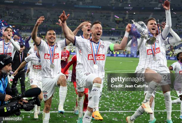 Gabriel Suazo, Thijs Dallinga, Brecht Dejaegere, Branco Van Den Boomen of Toulouse celebrate the victory following the French Cup final between FC...