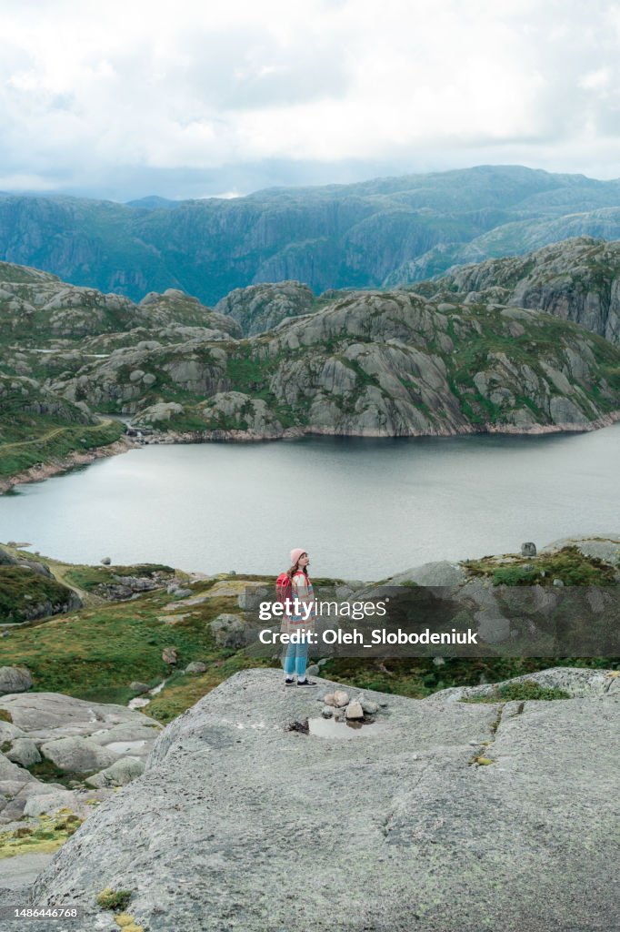 Woman hiking in mountains in Norway