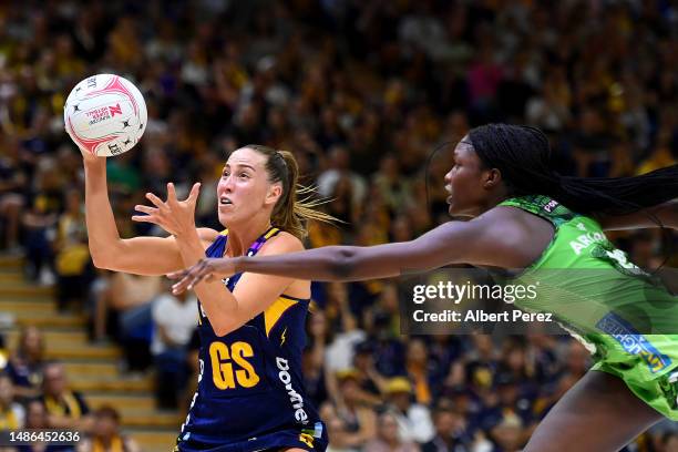 Cara Koenen of the Lightning and Sunday Aryang of the Fever compete for the ball during the round seven Super Netball match between Sunshine Coast...