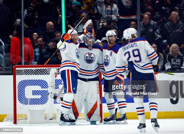 Mattias Ekholm, Stuart Skinner and Darnell Nurse of the Edmonton Oilers celebrate a 5-4 win against the Los Angeles Kings in Game Six of the First...