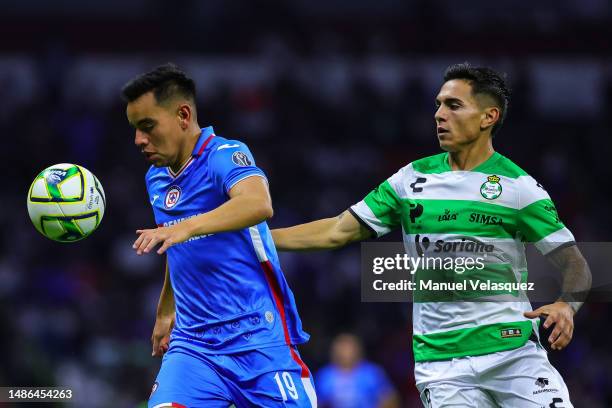 Carlos Rodríguez of Cruz Azul struggles for the ball against Lucas González of Santos during the 17th round match between Cruz Azul and Santos Laguna...