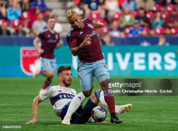 Tristan Blackmon of the Vancouver Whitecaps FC trips up Michael Barrios of the Colorado Rapids at BC Place on April 29, 2023 in Vancouver, Canada.