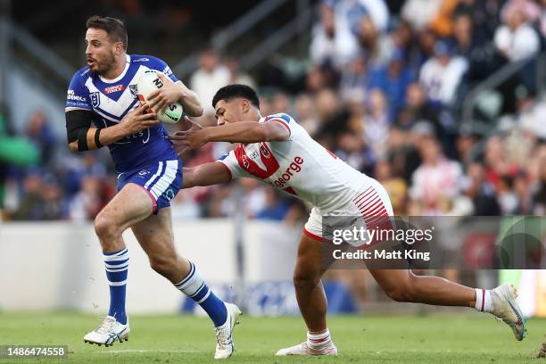 Josh Reynolds of the Bulldogs is tackled during the round nine NRL match between St George Illawarra Dragons and Canterbury Bulldogs at WIN Stadium...