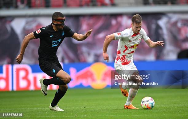 Dani Olmo of Leipzig is challenged by Kevin Akpoguma of Hoffenheim during the Bundesliga match between RB Leipzig and TSG Hoffenheim at Red Bull...