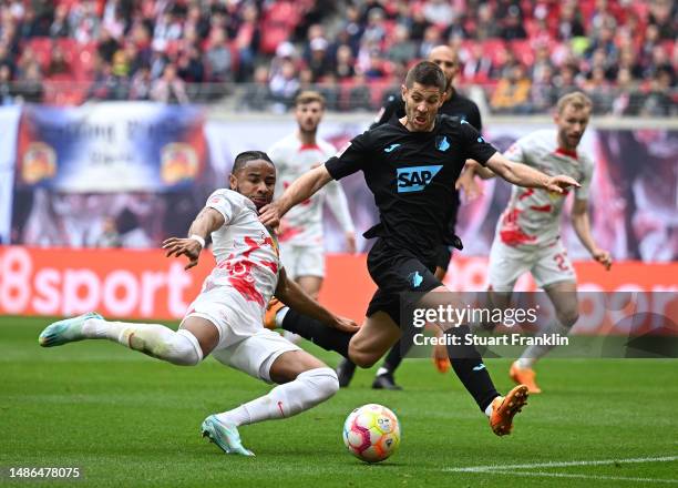 Christopher Nkunku of Leipzig is challenged by Andrej Kramaric of Hoffenheim during the Bundesliga match between RB Leipzig and TSG Hoffenheim at Red...