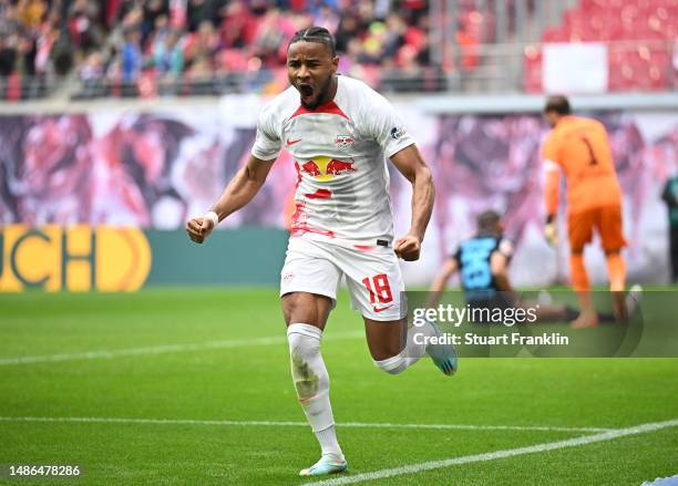 Christopher Nkunku of RB Leipzig celebrates after scoring his sides first goal during the Bundesliga match between RB Leipzig and TSG Hoffenheim at...