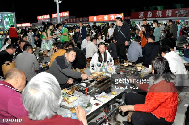 Tourists enjoy a barbecue feast at a gourmet marketplace during the five-day May Day Holiday on April 29, 2023 in Zibo, Shandong Province of China.
