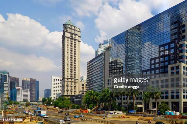 traffic situation on general sudirman street in front of the wisma nugra santana building - sudirman stock pictures, royalty-free photos & images