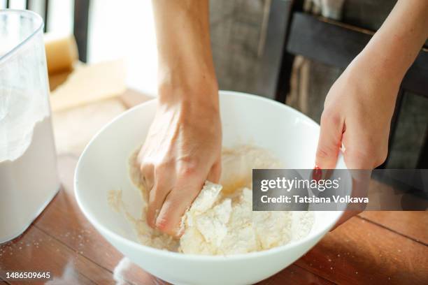 hands of unrecognizable white woman cooking dough in big white bowl - sifting stock pictures, royalty-free photos & images
