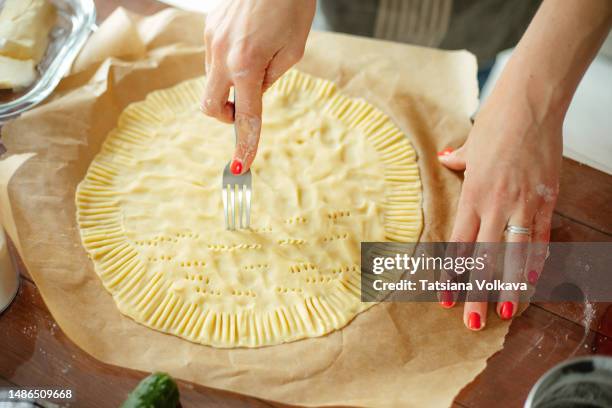 close up of woman hands with red nails docking dough with fork - dough stock pictures, royalty-free photos & images