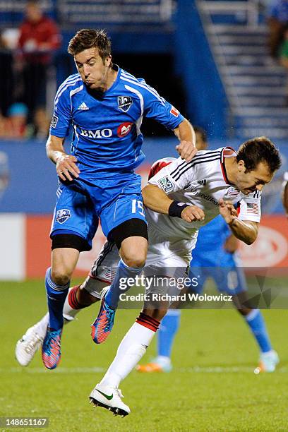 Jeb Brovsky of the Montreal Impact collides with A.J. Soares of the New England Revolution during the MLS match at the Saputo Stadium on July 18,...