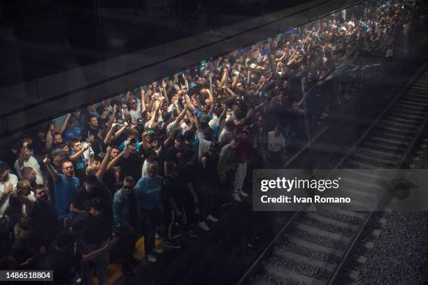 Napoli ultras stand on the platform of the metro on their way to reach the Diego Armando Maradona Stadium before what could be the decisive match to...