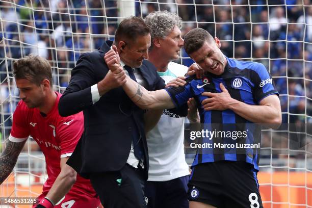 Robin Gosens of FC Internazionale reacts while receiving medical treatment after scoring the team's second goal during the Serie A match between FC...