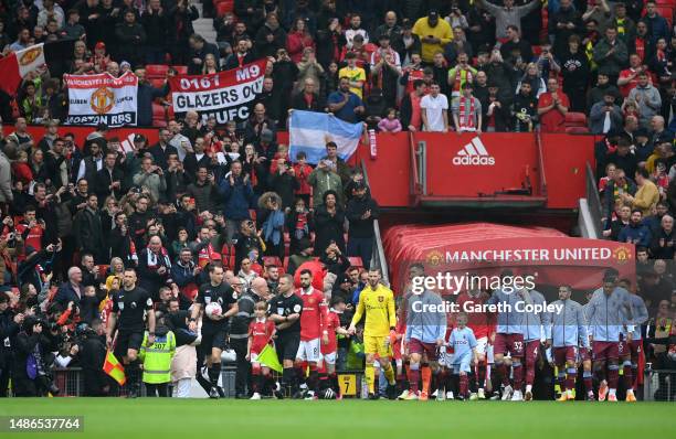 Manchester United and Aston Villa players enter the pitch prior to the Premier League match between Manchester United and Aston Villa at Old Trafford...