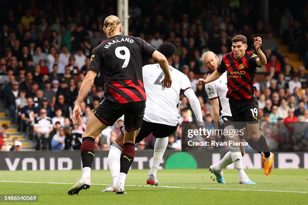 Julian Alvarez of Manchester City is fouled by Tim Ream of Fulham, which later results in a penalty for Manchester City during the Premier League...