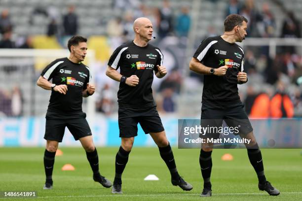 Referee Anthony Taylor and Assistant Referees Gary Beswick and Adam Nunn warm up while wearing the DXTL REFspect t shirts prior to the Premier League...