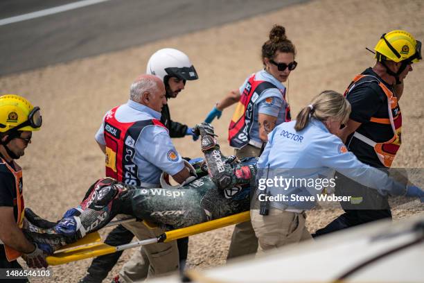 Miguel Oliveira of Portugal and CryptoDATA RNF MotoGP Team with medical staff on a stretcher after his crash with Fabio Quartararo of France and...