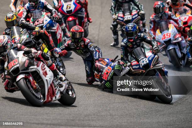 Fabio Quartararo of France and Monster Energy Yamaha MotoGP crashes into Miguel Oliveira of Portugal and CryptoDATA RNF MotoGP Team at turn two at...