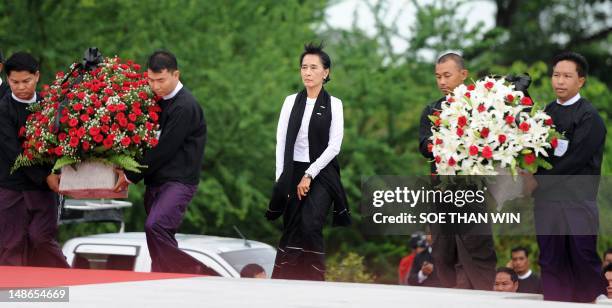 Myanmar opposition leader Aung San Suu Kyi arrives to lay wreaths and offer prayers in honour of her late father, independence hero General Aung San,...