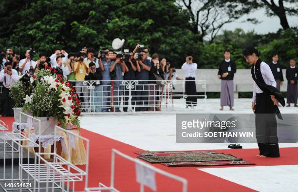 Myanmar opposition leader Aung San Suu Kyi prays in honour of her late father, independence hero General Aung San, during a ceremony to mark the...