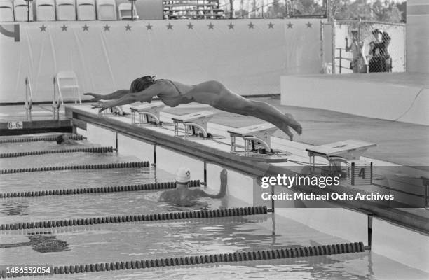 Female swimmer diving into a pool during the 1984 Summer Olympics, possibly at the Olympic Swim Stadium of the University of Southern California in...