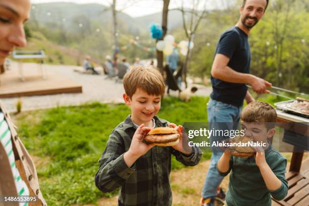 fourth of july barbecue with my family - eating burger stock pictures, royalty-free photos & images