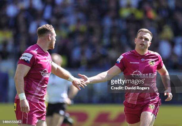 Sam Simmonds of Exeter Chiefs celebrates with teammate Joe Simmonds after scoring the team's first try during the Heineken Champions Cup Semi Finals...