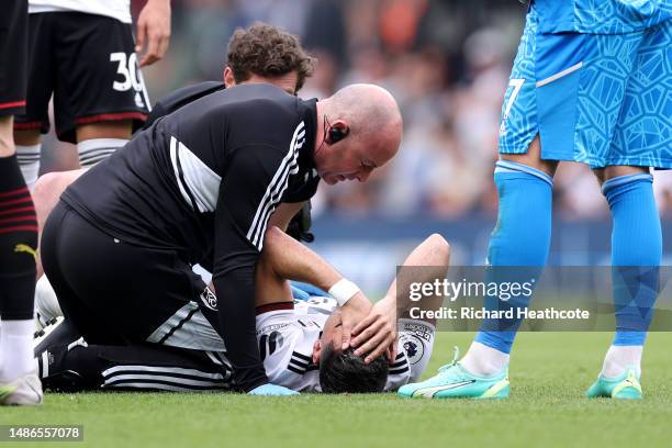 Andreas Pereira of Fulham receives medical treatment after colliding with Manuel Akanji of Manchester City during the Premier League match between...