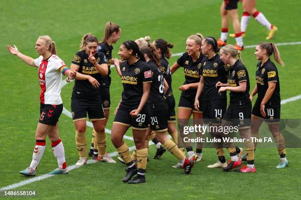 Courtney Sweetman-Kirk of Sheffield United celebrates with teammates after scoring the team's first goal while Rosanna Parnell of Southampton FC...