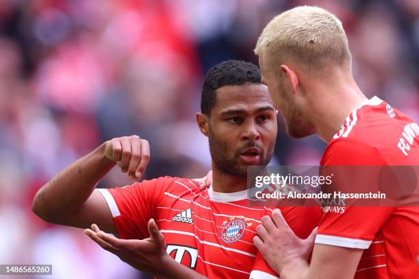 Serge Gnabry of FC Bayern Munich celebrates with teammate Matthijs de Ligt after scoring the team's first goal during the Bundesliga match between FC...